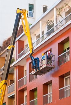 Crane working in a red building