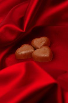 candy hearts on red satin background