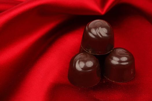 chocolate candy on red satin background