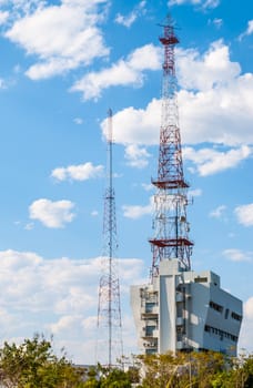 Telecommunication Antenna Tower on Building with blue sky and cloud