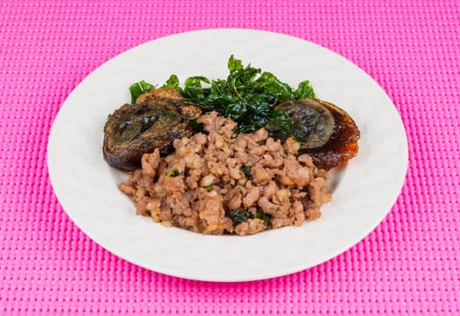 Fried century egg with pork and crispy basil leaf