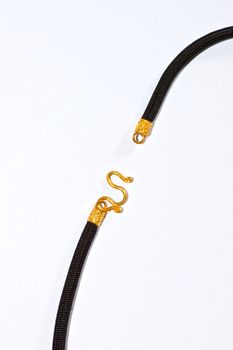 Black and gold rope on a white background.