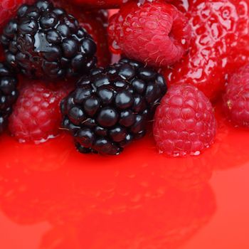 berry mixed pile in syrup isolated on white