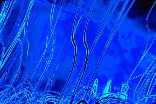 Abstract designs with bright trails on blue