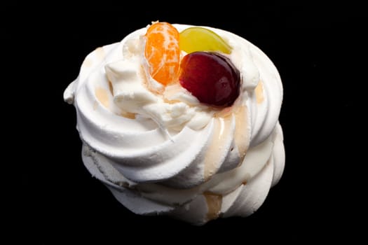 sweet cake with fruits isolated on black