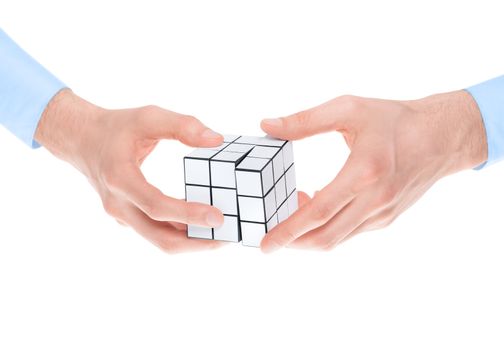 Male hands in shirtsleeves solving a blank white twist puzzle. Isolated on white.