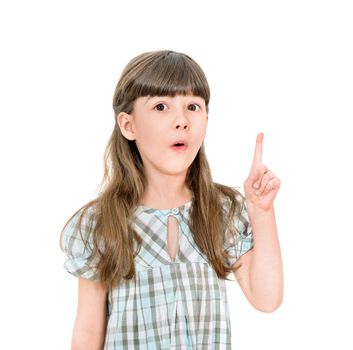 Clever little girl with a bright idea pointing upwards with her finger to gain attention. Isolated on white with blank copyspace above her finger.