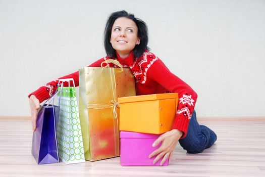 Glad lady indoors with gift shopping presents