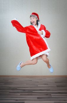 Crazy lady jumping indoors in Santa costume