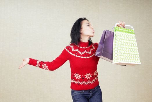 Playful lady with gift bags in the red sweater