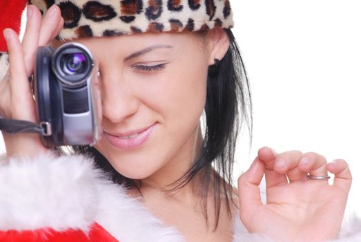 Attractive lady in Santa costume holding video camera