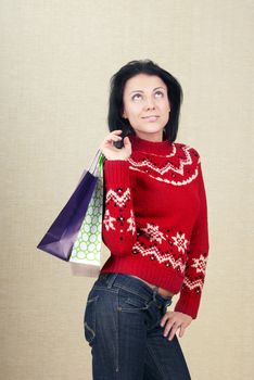 Smiling lady with shopping bags indoors