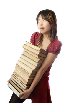 Young schoolgirl carrying numerous heavy books