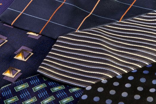 Row of different ties with mainly blue colours
