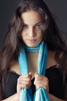 Front-view photo of the gorgeous model holding blue scarf