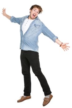 Man jumping excited in full body isolated on white background. Casual funny Caucasian guy in his twenties.