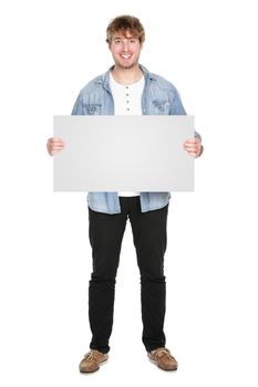 Man showing sign standing in full body. Casual young guy holding blank empty banner sign isolated on white background. Caucasian male model in his twenties.