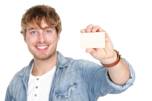 Man showing business card sign. Young casual happy smiling man holding blank empty business card. Caucasian male model in his 20s.