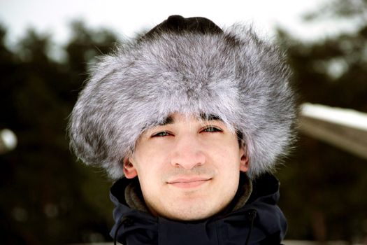 A portrait of man is in a fur cap