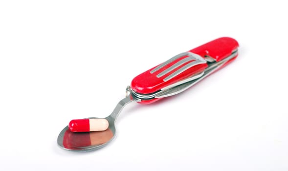 Swiss army knife , with capsule on spoon