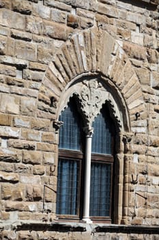 Florence - the stone wall Palazzo Vecchio with the beautiful window