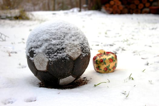 Beautifull Christmas apple and a soccer ball in the snow.