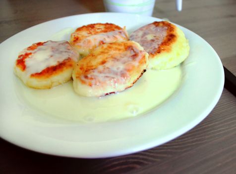 Cheesecakes with condensed milk on a white plate. Russian cuisine.