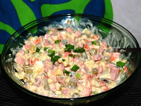 salad in the Russian tradition in a bowl, sprinkled with green onions