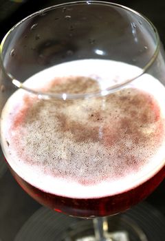 A glass of pink champagne or sparkling wine