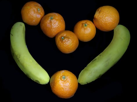 fruit love. Heart from bananas and tangerines