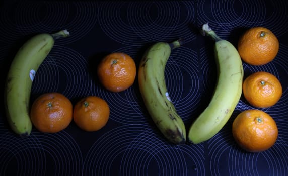 fruit love. Heart from bananas and tangerines
