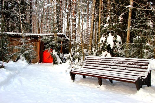 park bench in winter snow bound landscape