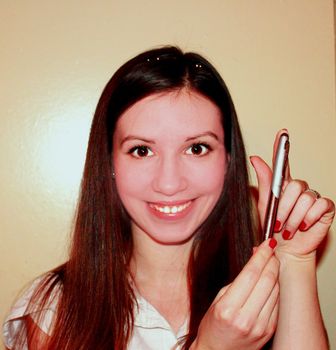 portrait of smiling girl in office clothes with a pen