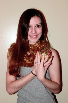 Girl with a New Year's apple. brown eyes, brown hair