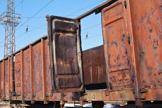 Abandoned metal rusty goods wagon, open door, concept