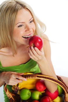 woman holds a basket of fruit on a white background