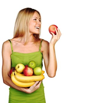 woman holds a pile of fruit on a white background