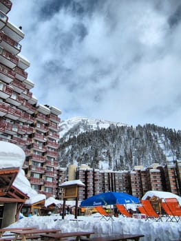 A moutnain hotel in front of a cloudy but blue sky