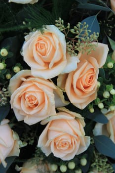 Big pale orange flowers in a wedding bouquet