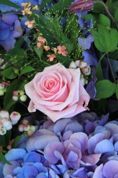Floral arrangement with blue hydrangea and pink rose