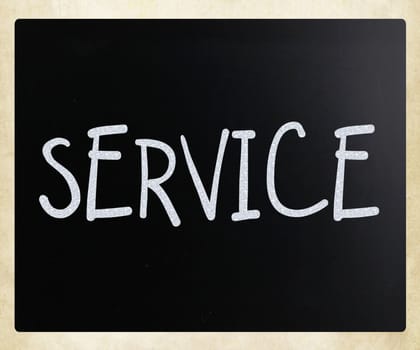 "Service" handwritten with white chalk on a blackboard