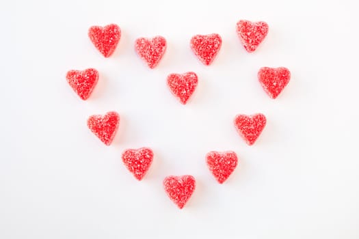 Jelly (gummy) sugar coated candy hearts arranged in the shape of a heart. Isolated on white.