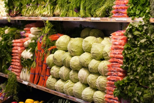 Cabbage and carrots on grocery stor shelf