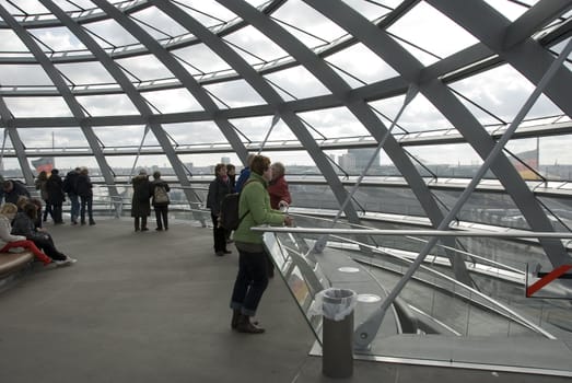 people in the Cupola on top of the Reichstag building in Berlin