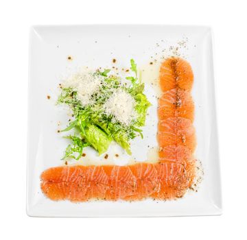 Fish Carpaccio with salad and mozzarella on a white