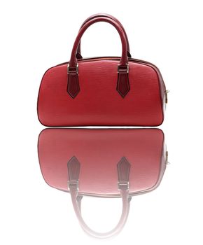 red fake leather woman bag with its reflection