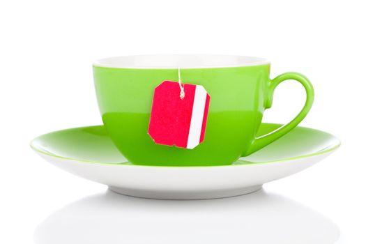Green tea cup and teabag. Isolated on white background