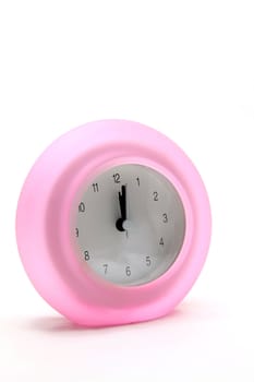 pink round modern alarm clock side perspective
