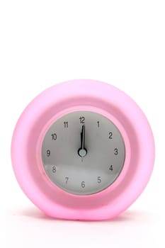 pink round modern alarm clock front perspective