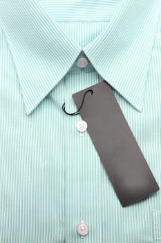 Close up view of a generic line pattern green business shirt with a blank label